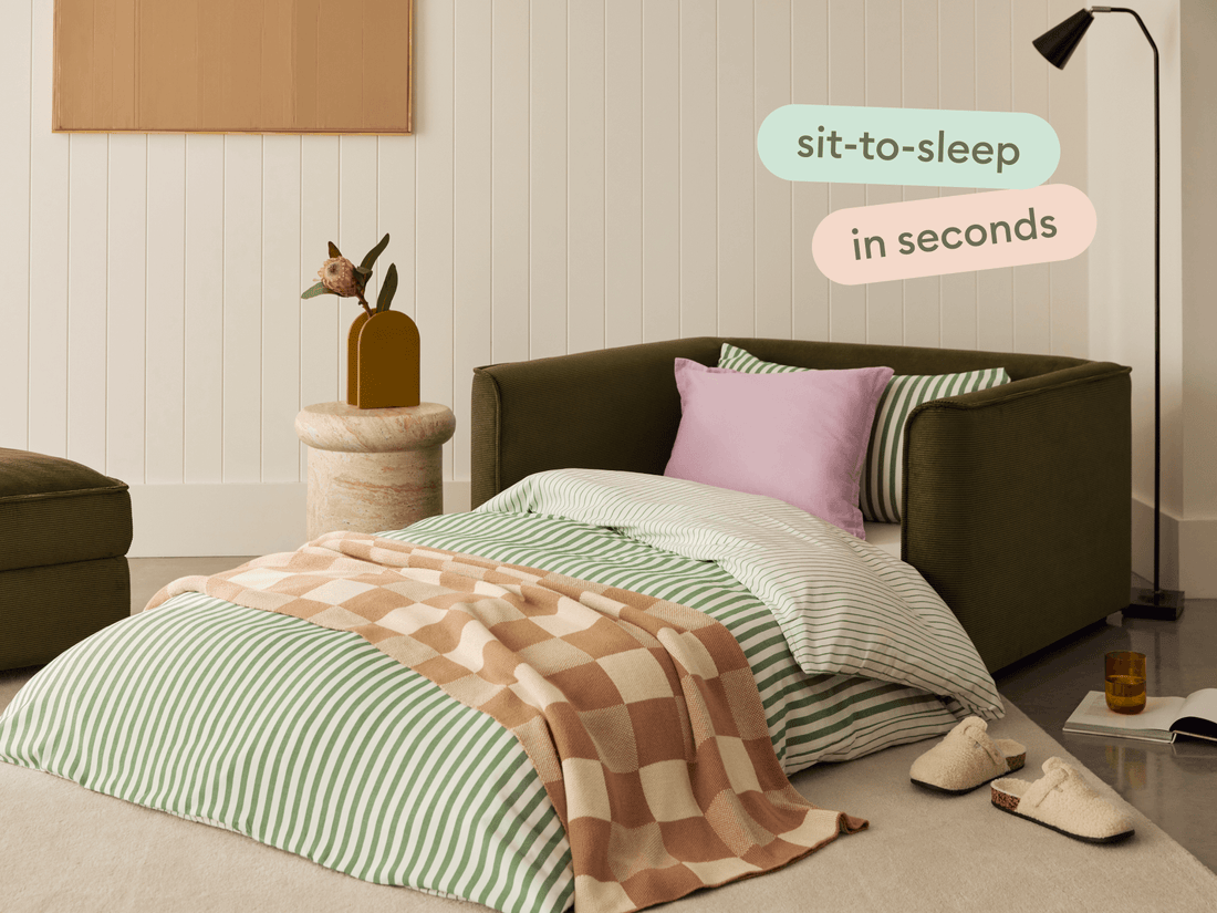 laid out sofa bed with sheets and pillows