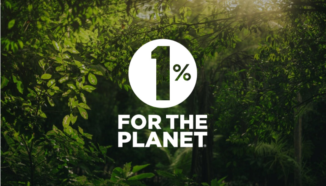 A lush green forest background with vibrant leaves; overlaid text: "1% FOR THE PLANET" in white and green font.